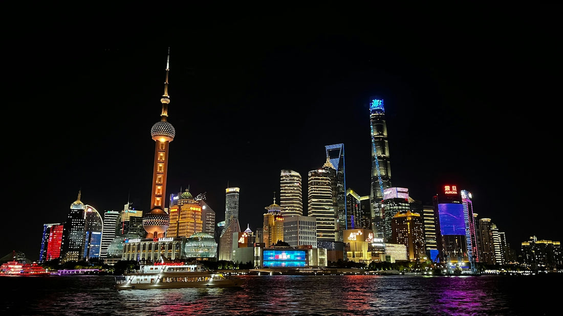 A view of a city at night from the water